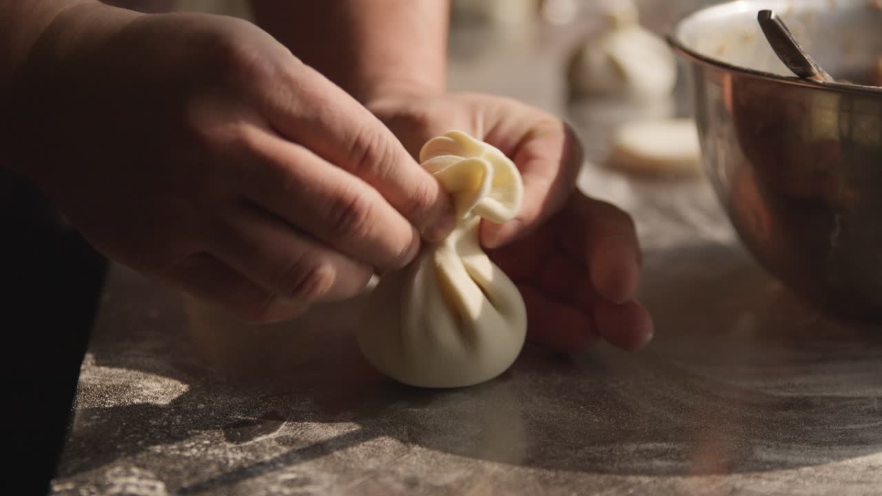 Georgian chef making khinkali dumplings, traditional Georgian food, closeup on hands