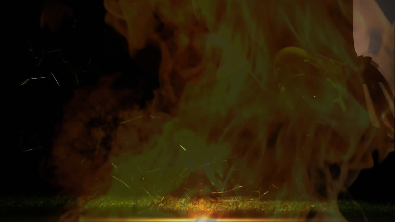 Rugby player kicking ball with fire 