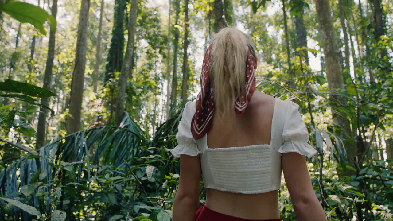 beautiful woman walking in forest exploring lush tropical rainforest alone enjoying beauty of nature lost on spiritual journey