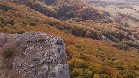 aerial panning high angle shot of big high rock on the edge of a mountain-2