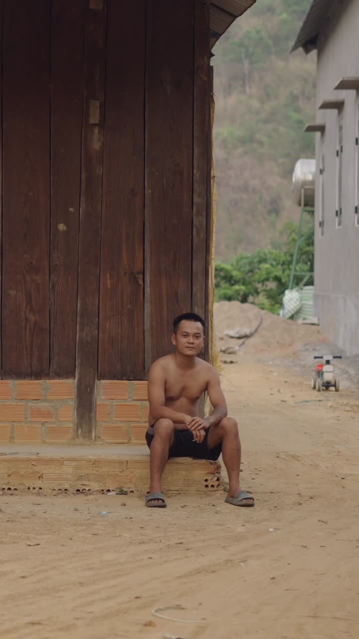 A man sitting outdoors in a rural area