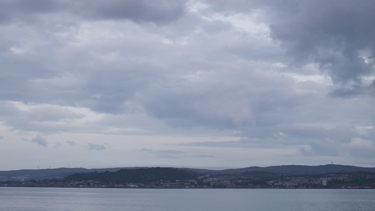 Overcast Sky Over Water and Distant City Landscape at Dusk