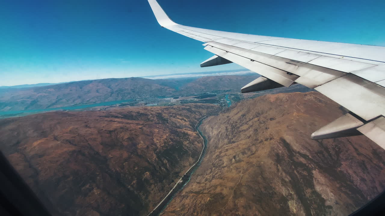 Flying over mountain ranges, Queenstown, New Zealand. A view from airplane window