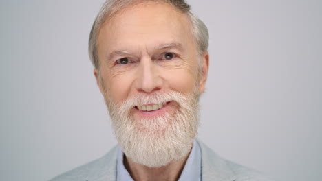 Joyful-man-looking-to-camera-indoors.-Mature-man-smiling-in-modern-studio.