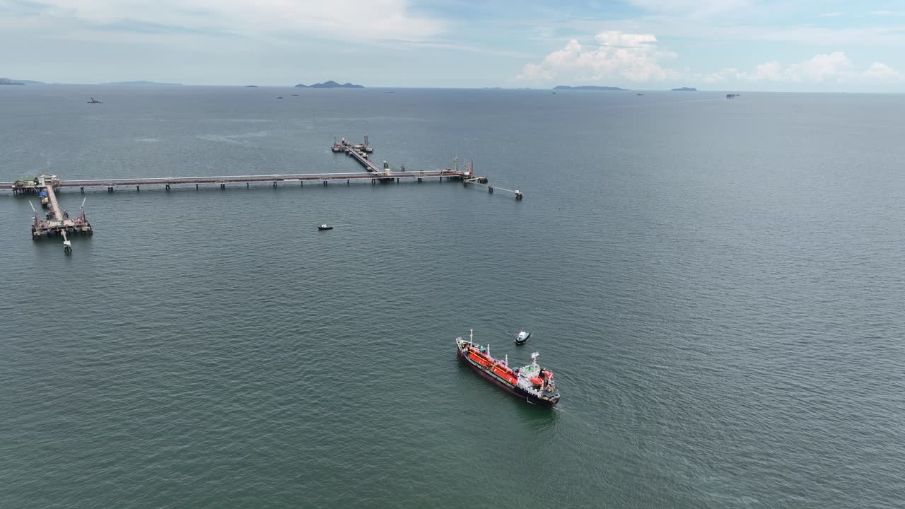 An aerial drone video of tanker ship in the port of Thailand. Aerial top down, industrial transportation of liquid chemical products.