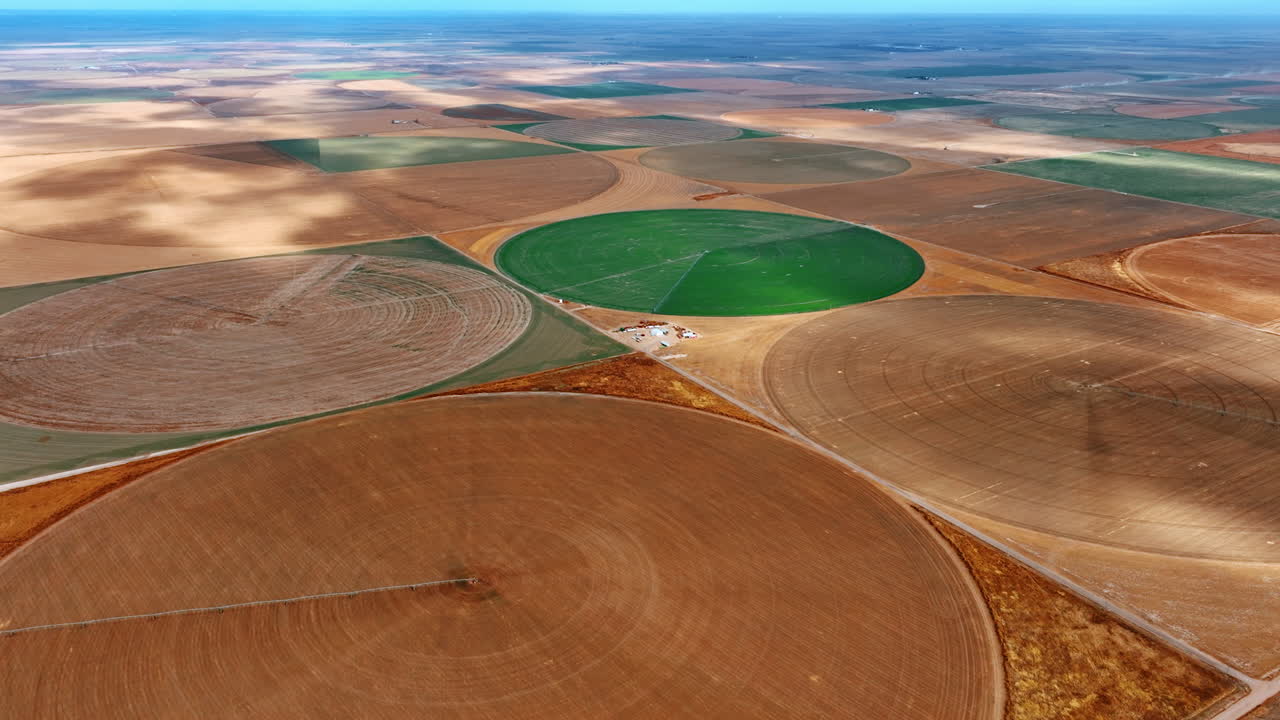 Amazing huge field with circle farms. Drone flight above the agricultural plantations with center pivot irrigation.