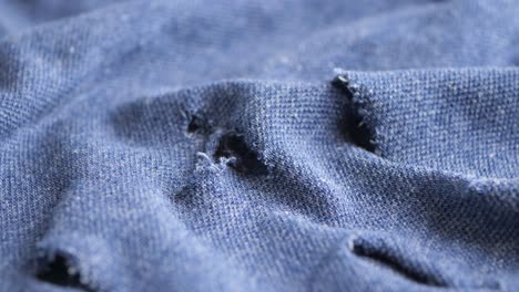 close-up of ripped blue denim fabric