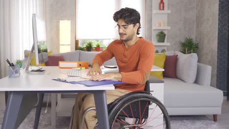 frustrated disabled businessman working in his home office.