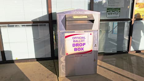 woman votes in election by mail at official ballot drop box sign for american democratic government presidential race by casting ballot in slot, mail-in letter