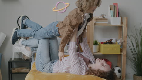 mother and son playing in a bedroom