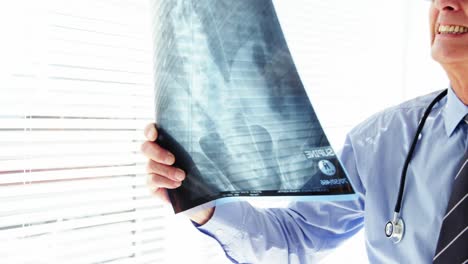 male doctor examining x-ray