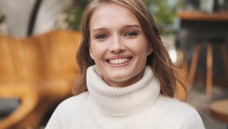 caucasian woman smiling at the camera.