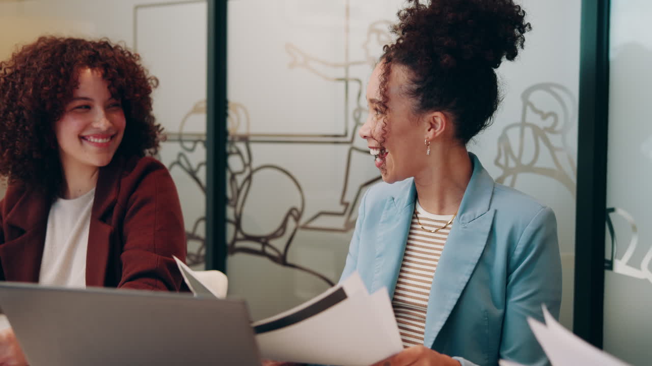 Two women celebrate a success in the office