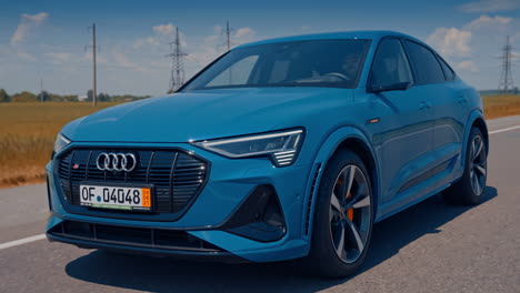 audi customers test the new audi e-tron electric car. electric metallic blue audi e-tron 55 quattro suv.
