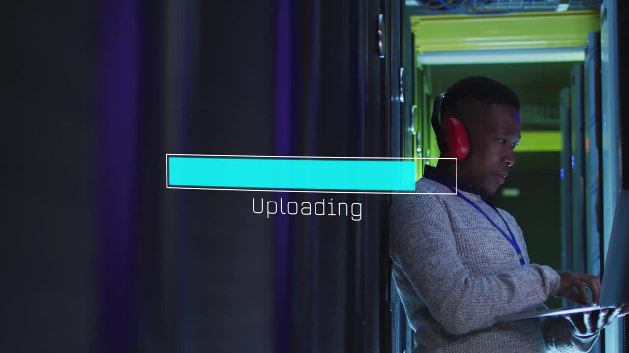 Animation of loading bar over african american man working in server room