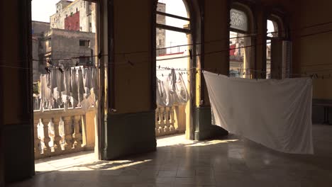 White-Laundry-on-balcony-moving-slowly-in-the-wind-in-sunny-Havana-city