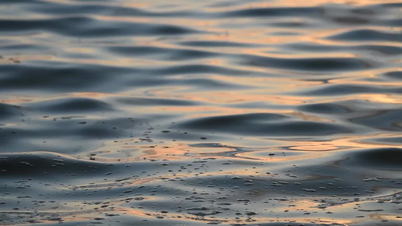 sunrise reflection on water closeup on ripples of the gulf of Mexico on a summers day background