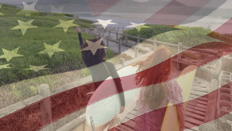animación de la bandera de los estados unidos de américa sobre un hombre y una mujer felices con tablas de surf en la playa