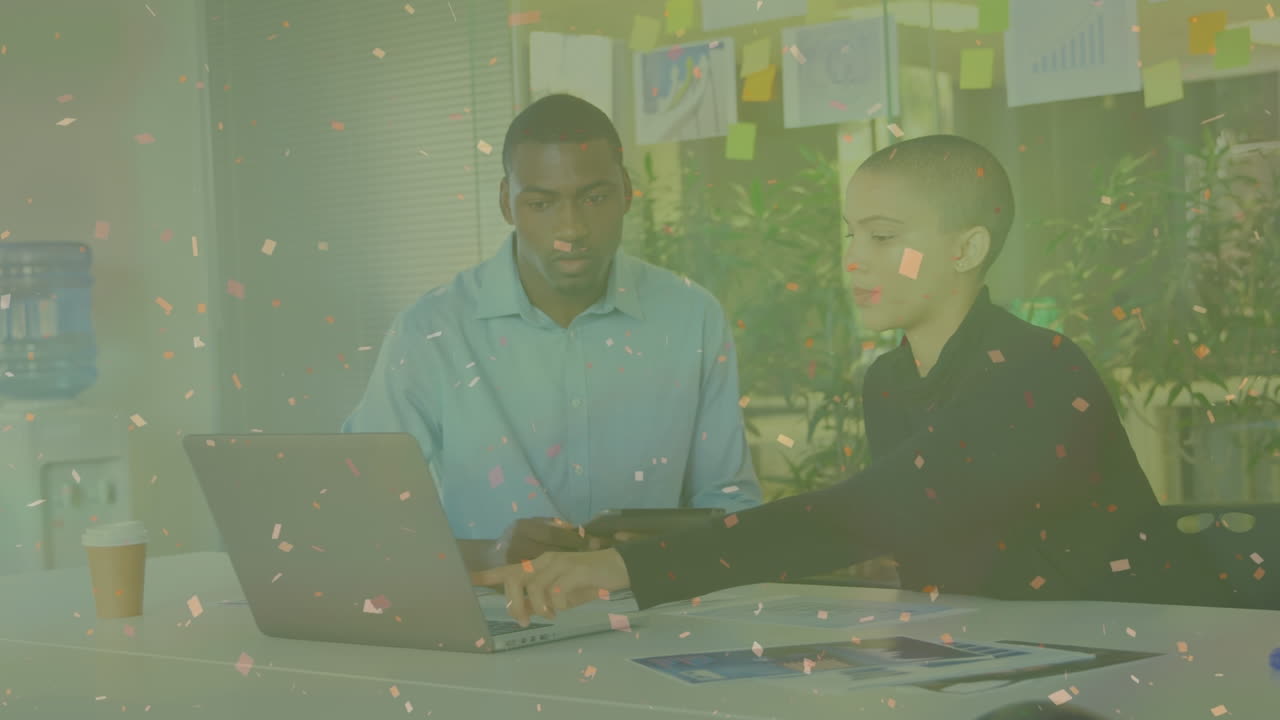 Animation of white spots over diverse business people using laptop