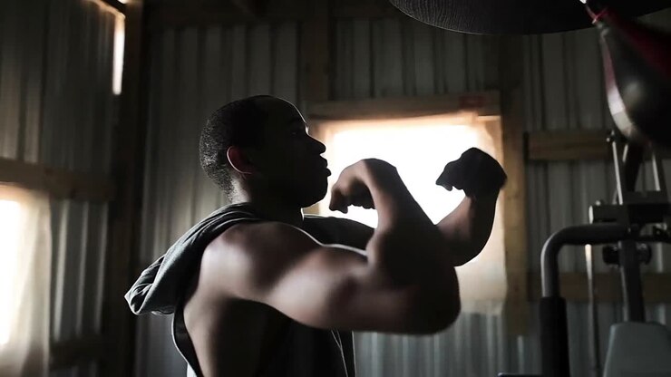 Boxer punching a punching bag in the gym