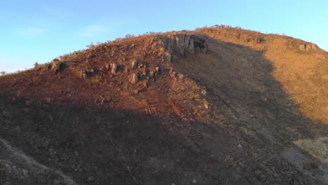 Slow-aerial-pan-out-of-a-large-mountain-outside-of-Colima,-Mexico-at-sunset