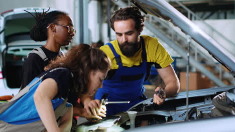 team of technicians fixing car