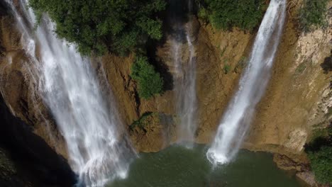 a stunning drone shot of thi lo su waterfall seen from above, located deep in the jungle, off the beaten track in the backpacker's paradise country of thailand in the area of umphang in southeast asia