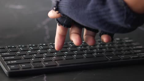 a hand typing on a keyboard