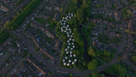 top down view of famous bolwoningen at 's-hertogenbosch with sunset, aerial