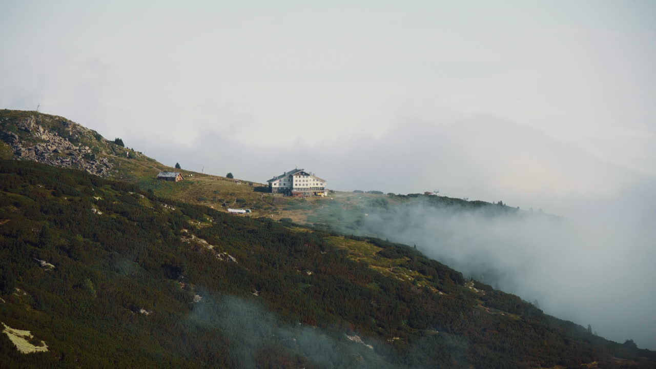 Hut "Seven Rila Lakes" located on the Rila Mountains, Bulgaria. There are low clouds around it