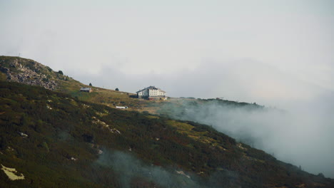 hut "seven rila lakes" located on the rila mountains, bulgaria. there are low clouds around it