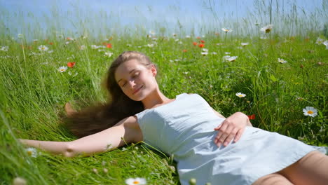 woman relaxing in a field of wildflowers
