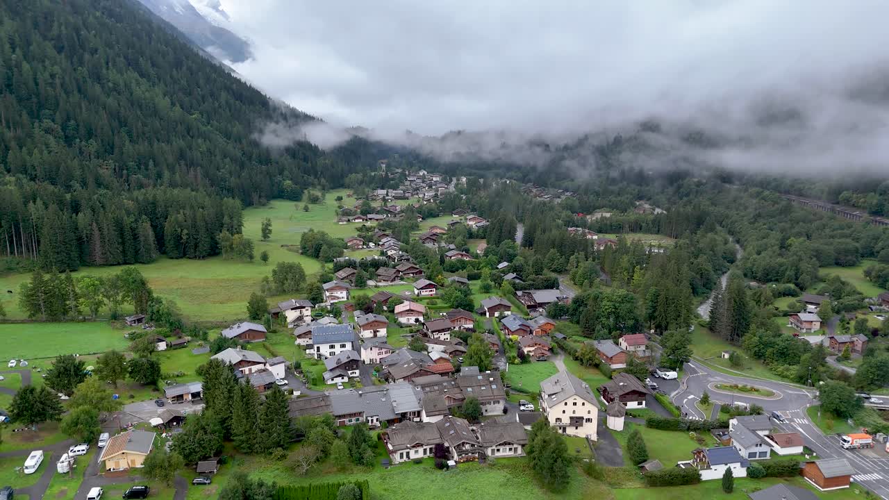 High resolution 4k drone aerial video of the beautiful town of Argentiere France an integral part of the famous TMB- Tour du Mont Blanc trail during a foggy peaceful morning in the month of September