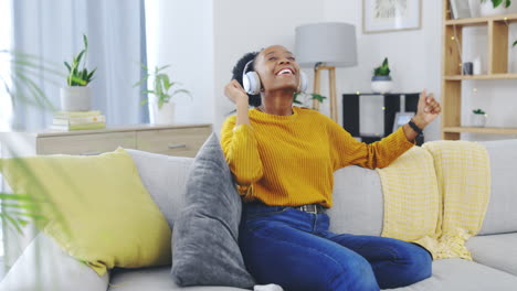 Dance,-phone-and-music-with-black-woman-on-sofa