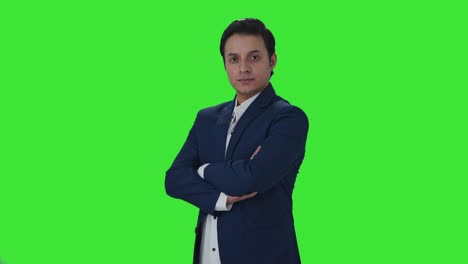 Portrait-of-confident-Indian-journalist-standing-crossed-hands-Green-screen