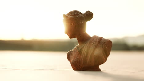 sunset silhouette of a classical female bust statue