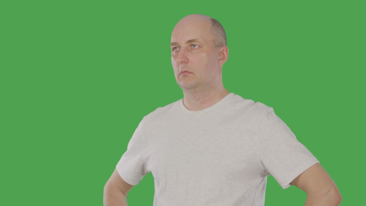 Bald man nodding head and agreeing with conversation isolated on green background. Alpha channel, keyed green screen