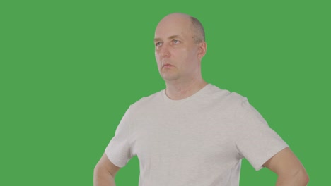 bald man nodding head and agreeing with conversation isolated on green background. alpha channel, keyed green screen