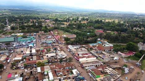 aerial view of cars and people at a open air market, in africa - reverse, drone shot