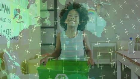 Animation-of-rotating-globe-over-happy-biracial-schoolboy-holding-recycling-crate-in-classroom