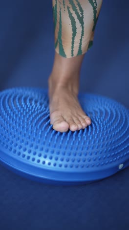 balance exercise with foot on a stability ball