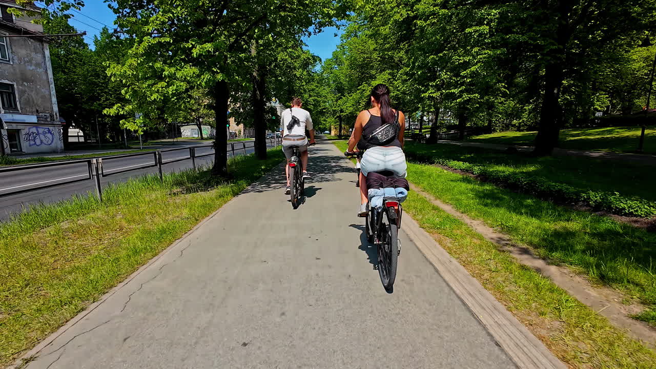 Couple Enjoying a Scenic Bike Ride on a Sunny Day