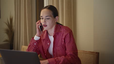 Businesswoman making call home office closeup. Relaxed lady browsing laptop