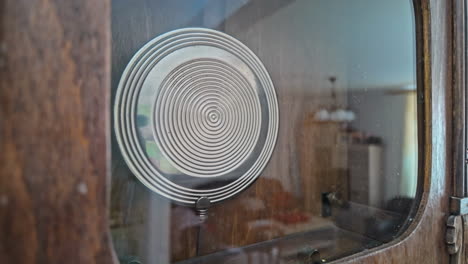 close-up of an antique wall clock's pendulum in motion