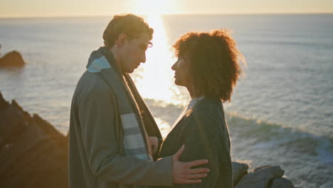 multiracial lovers hugging together at evening sea closeup. enamoured couple