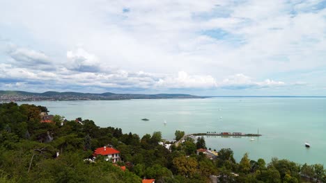 gorgeous long exposure timelapse video from hungary, tihany peninsula, looking towards the northern part of lake balaton including the ferry port and sailing boats with the hills in the background