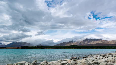 clouds swirl and roll dramatically in time lapse above mountain ranges at lake tekapo