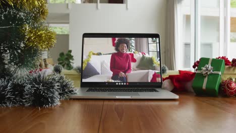 Lächelnde-Afroamerikanische-Frau-Mit-Weihnachtsmütze-Bei-Weihnachtsvideoanruf-Auf-Dem-Laptop