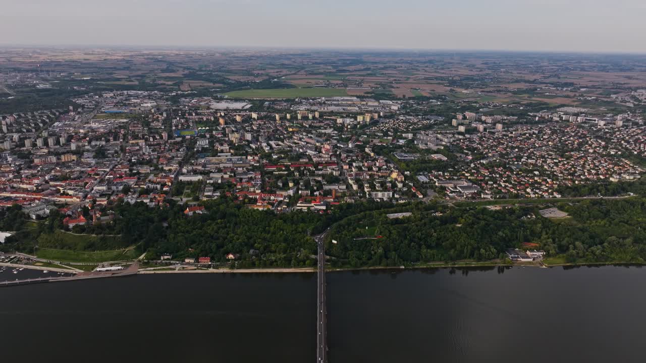 Wide aerial show Most Legionów crossing Vistula River into central Płock, Poland