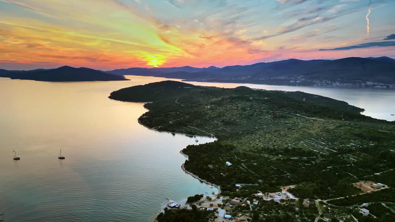 Aerial, drone view of land on the shore of the Adriatic sea in Croatia, at sunset